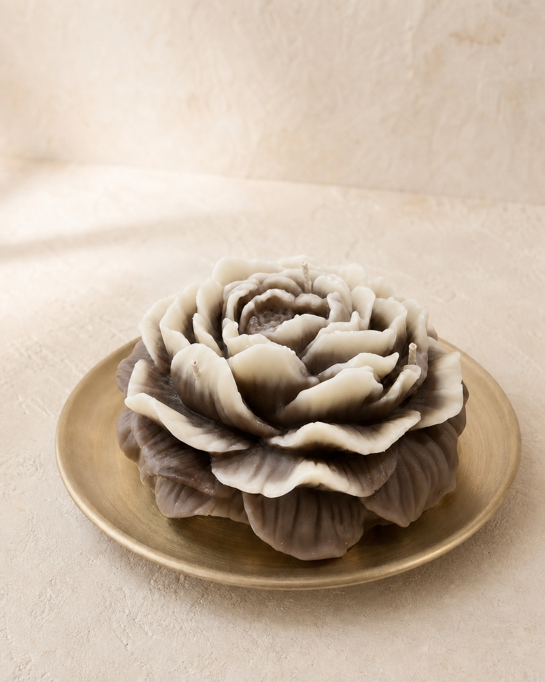 Large ivory and taupe sculptural peony candle arranged in a flower bowl