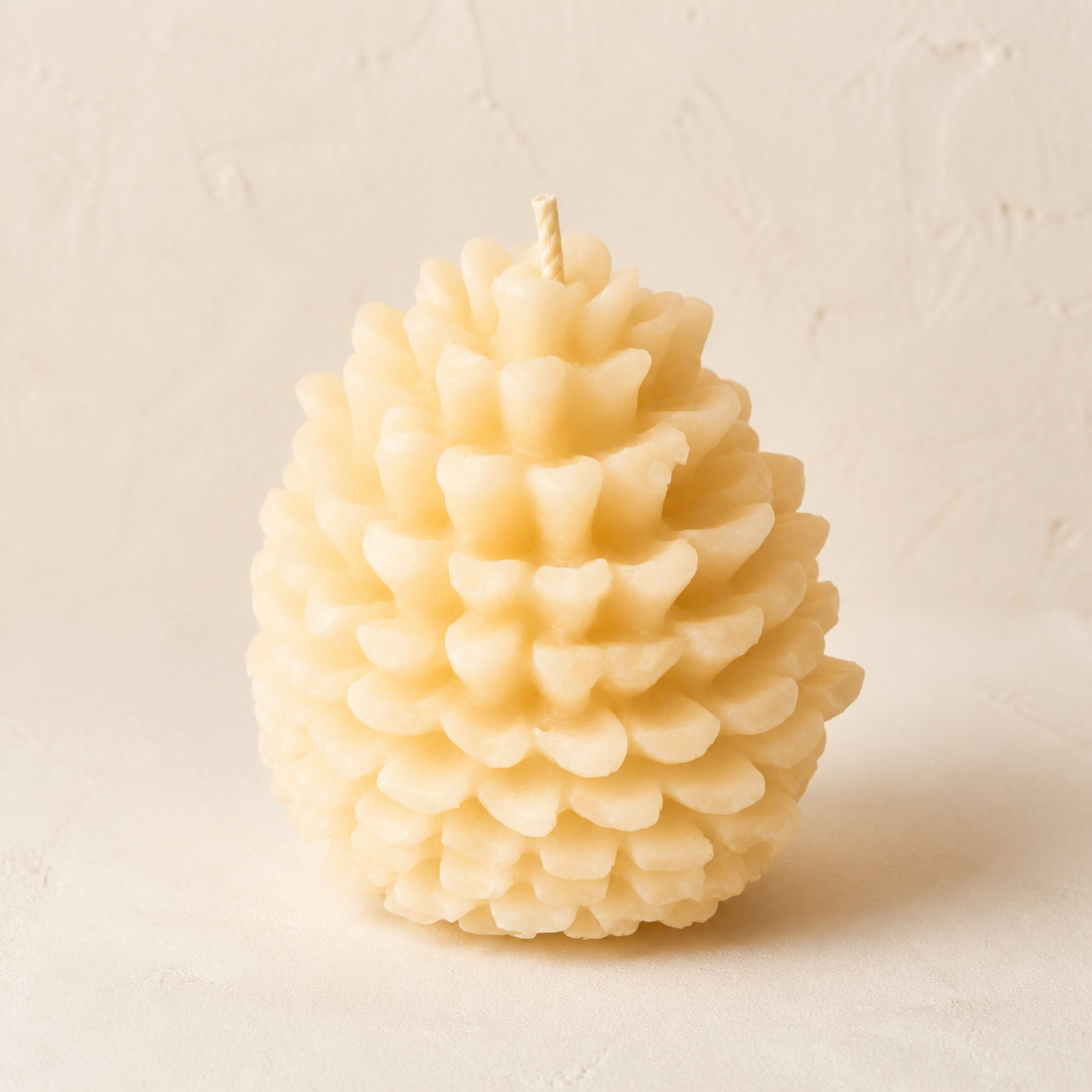 Ivory rounded pinecone candle