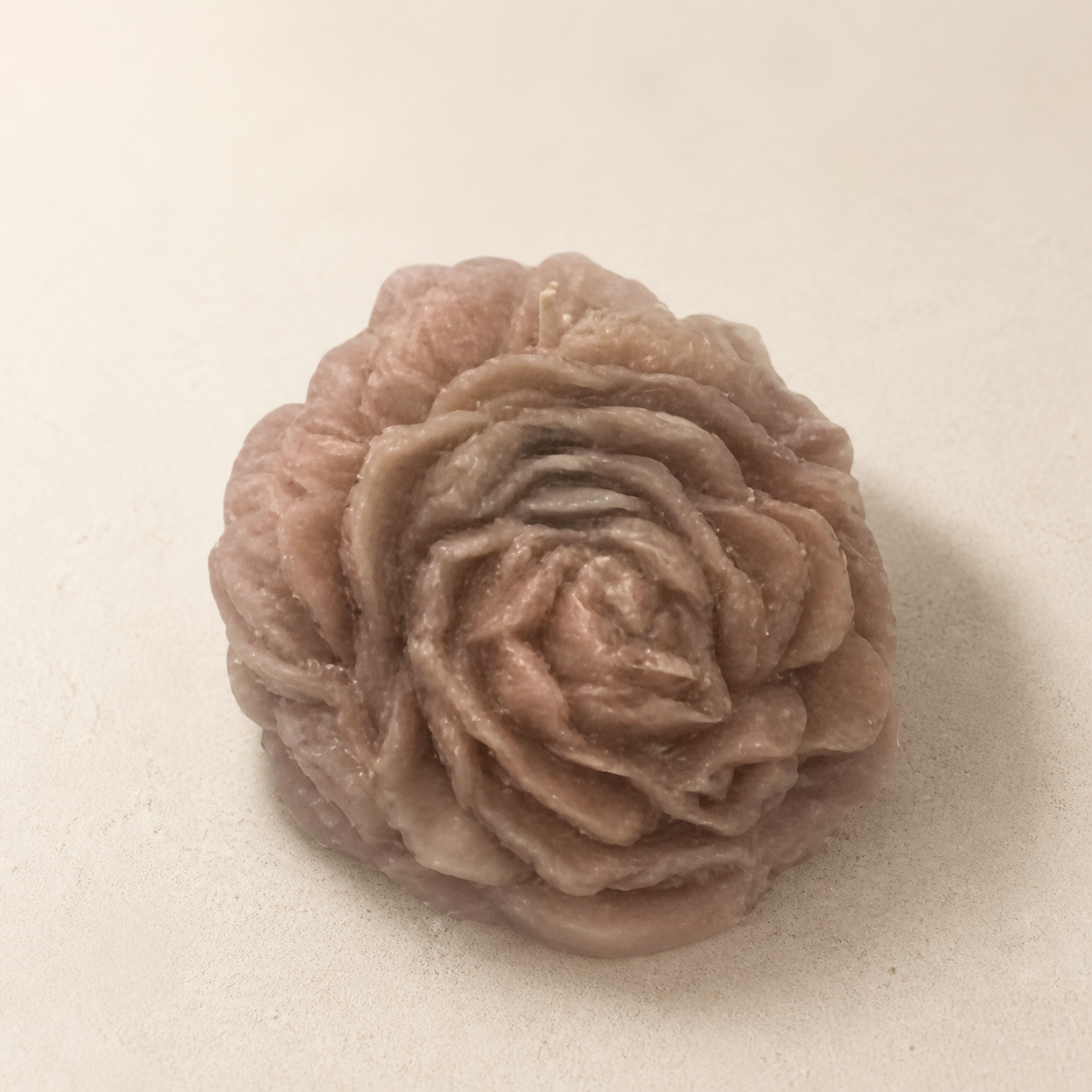 Small earth-tone sculptural rose candle