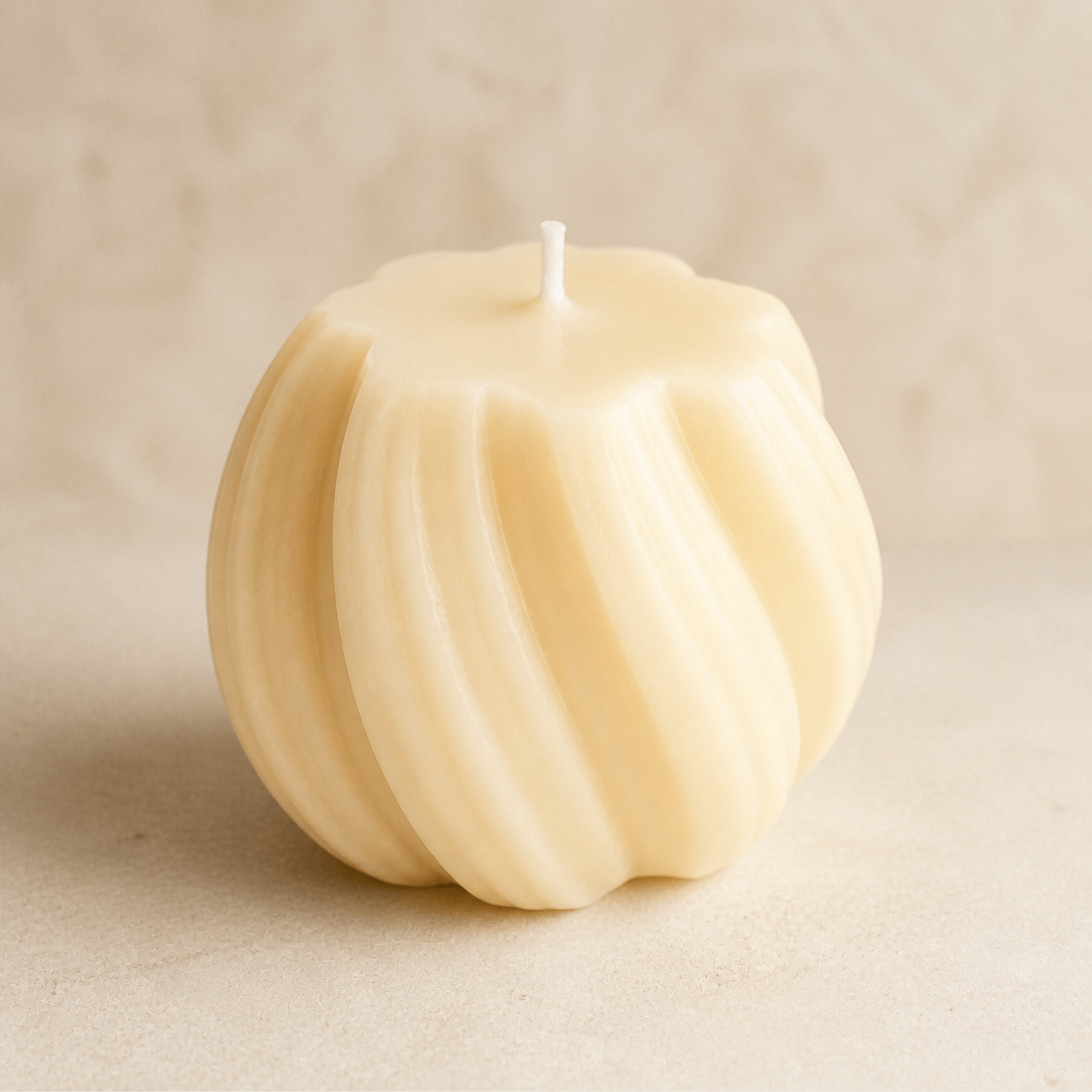 Small ivory spiral sphere candle