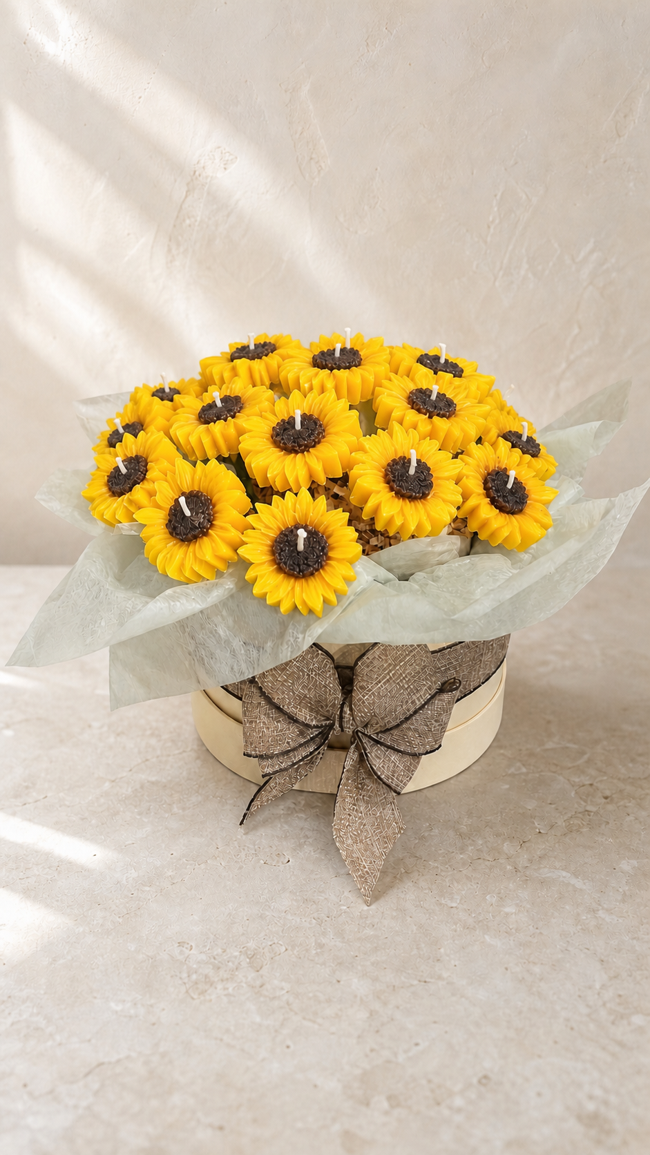 Bright sunflower candle bouquet arranged in an ivory hatbox with neutral ribbon