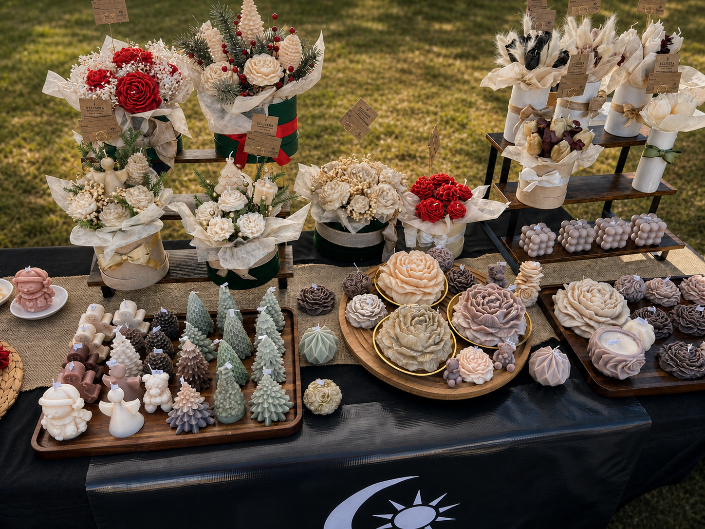 Wide selection of handcrafted Eclisera candles and floral candle bouquets at a local farmers market
